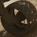 A puncture (centre right) in one of Curiosity's wheels. The sequence of cutouts in the lower right are deliberate and imprint 'JPL' in Morse code as the wheels roll across the Martian surface.