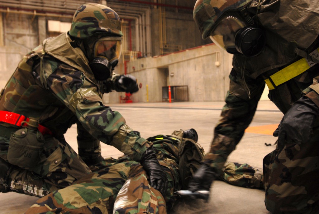 US Air Force officers administer a nerve agent autoinjector containing atropine and 2-PAM during a readiness exercise.